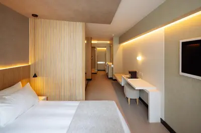 a hotel room with a bed and a desk and a television at Hotel Arconte, Adults Only in Barcelona