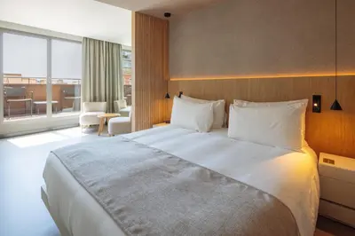 a hotel room with a large bed and a large window at Hotel Arconte, Adults Only in Barcelona