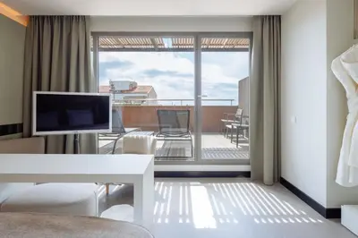 a living room with a view of a balcony at Hotel Arconte, Adults Only in Barcelona