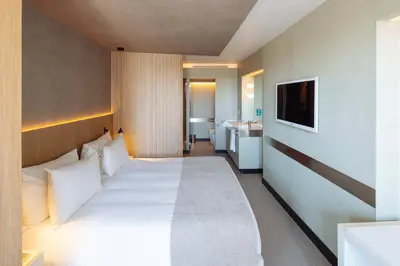 a hotel room with a bed and a television at Hotel Arconte, Adults Only in Barcelona