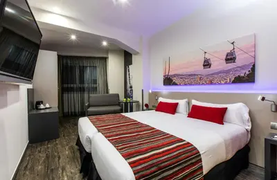 a hotel room with a large bed and a chair at Leonardo Boutique Hotel Barcelona Sagrada Familia in Barcelona