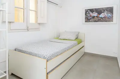 a small bedroom with a bed in a room at Private Roof Top Sant Antoni in Barcelona