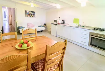 a kitchen and a table with a plate of fruit on it at Private Roof Top Sant Antoni in Barcelona