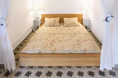 a bedroom with a large bed with two lamps at Private Roof Top Sant Antoni in Barcelona
