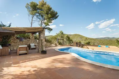 an outdoor swimming pool with a pergola next to a swimming pool at HHBCN Can Surià in Olivella