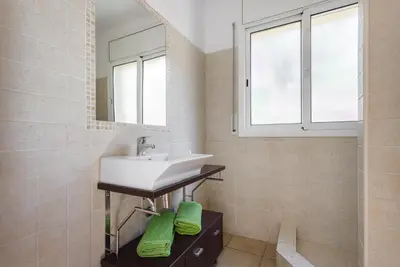 a bathroom with a sink and a mirror at HHBCN Can Surià in Olivella