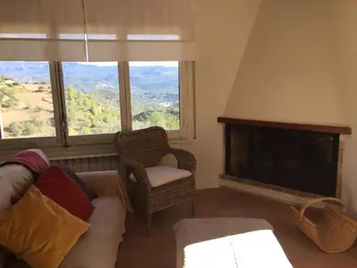 a living room with a couch and a fireplace at Montserrat La Calsina in Monistrol