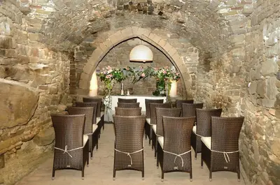 a room with chairs and a table in a stone wall at Fonda La Masia Del Sola in Monistrol de Calders