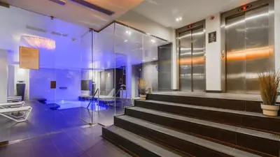 a lobby with a staircase in a building at Grums Hotel & Spa in Barcelona