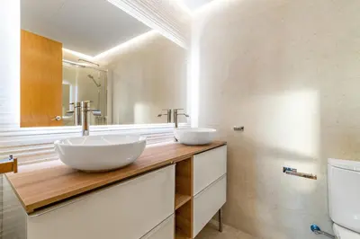 two sinks on a wooden counter in a bathroom at Tendency Apartments 3 in Barcelona