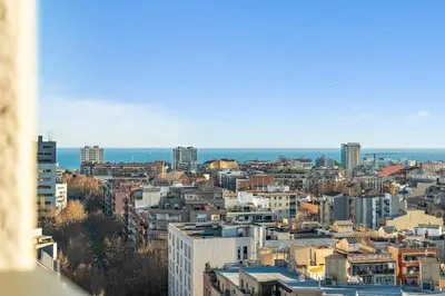 a view of a city with buildings and the ocean at Tendency Apartments 3 in Barcelona
