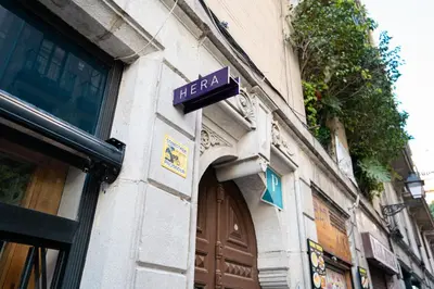 a sign on the side of a building at Hostal Hera in Barcelona