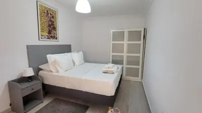 a small bedroom with a bed with a teddy bear on it at APARTAMENTS B O D CoLLBLANC in Hospitalet de Llobregat