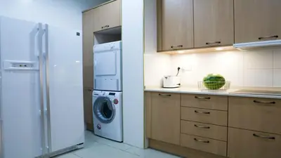 a kitchen with a refrigerator and a washer and dryer at Balcones y Vistas en el Centro de la Ciudad in Barcelona