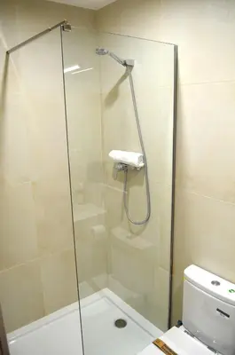 a bathroom with a sink and a toilet and a mirror at Poble Sec Apartments in Barcelona