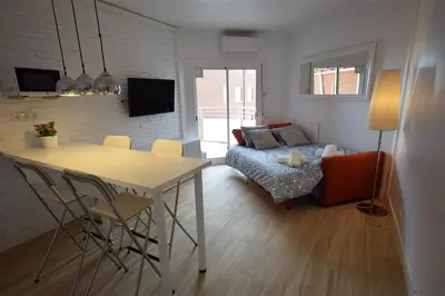 a living room with a table and a couch at Apartamento Playa Mar in Castelldefels