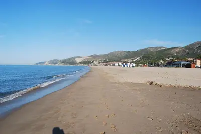 a person taking a picture of the beach at Apartamento Playa Mar in Castelldefels
