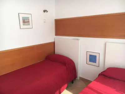 a bedroom with two beds and a red blanket at Nice and quiet flat in Premià de Mar - HUTB 01790 in Premiá de Mar
