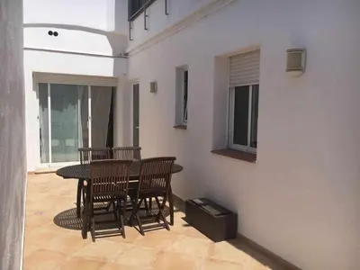 a dining room with a table and chairs on a patio at Nice and quiet flat in Premià de Mar - HUTB 01790 in Premiá de Mar