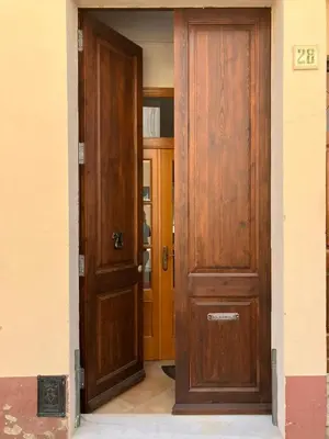 an open door of a house with two wooden doors at Nice and quiet flat in Premià de Mar - HUTB 01790 in Premiá de Mar