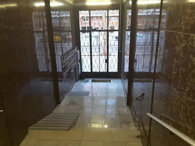 a hallway with a door and a staircase in a building at Apartamento Gran Via de les Corts Catalanes in Barcelona