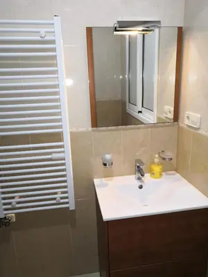 a bathroom with a sink and a mirror at Apartamento Gran Via de les Corts Catalanes in Barcelona