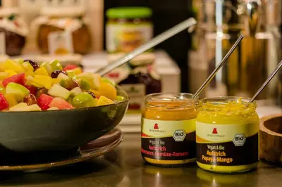 a bowl of fruit next to two jars of honey at Motel One Barcelona-Ciutadella in Barcelona