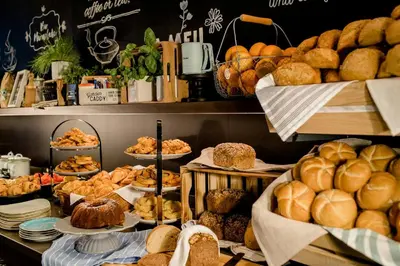 a bakery with lots of bread and pastries on display at Motel One Barcelona-Ciutadella in Barcelona