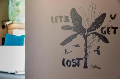 a sticker of a face with butterflies on a wall at Motel One Barcelona-Ciutadella in Barcelona