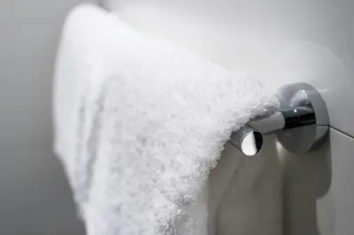 a close up of a shower head with white towel at Motel One Barcelona-Ciutadella in Barcelona
