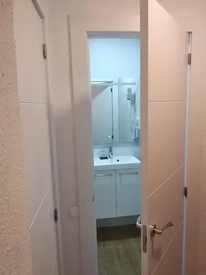 a bathroom with a white sink and a mirror at Hostal Restaurante Cornella in Cornellà de Llobregat