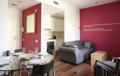 a living room with a table and a couch at MH Apartments Suites in Barcelona