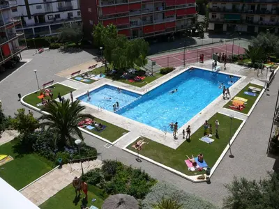 an overhead view of a large swimming pool in a city at Oasis Near Barcelona Pool Tennis Beach in Sant Andreu de Llavaneres