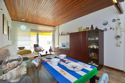 a living room with a glass table in a room at Oasis Near Barcelona Pool Tennis Beach in Sant Andreu de Llavaneres