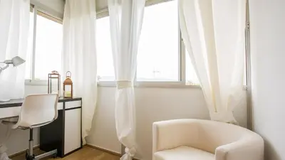 a white chair in a room with a desk and window at GAVA 2 BEACHFRONT PENTHOUSE in Gavà