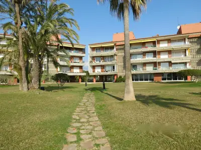 a walkway in the grass in front of a building at GAVA 2 BEACHFRONT PENTHOUSE in Gavà