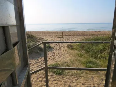 a view of the beach from the porch of a beach house at GAVA 2 BEACHFRONT PENTHOUSE in Gavà