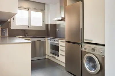 a kitchen with a stainless steel refrigerator and a dishwasher at Mar Bella Beach Apartments in Barcelona
