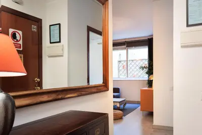a mirror on a wall next to a room at Portal Del Angel Barcelona Apartment in Barcelona