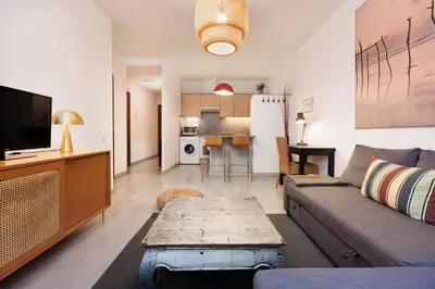 a living room with a couch and a table at Portal Del Angel Barcelona Apartment in Barcelona