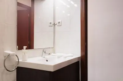 a bathroom with a sink and a mirror at Portal Del Angel Barcelona Apartment in Barcelona