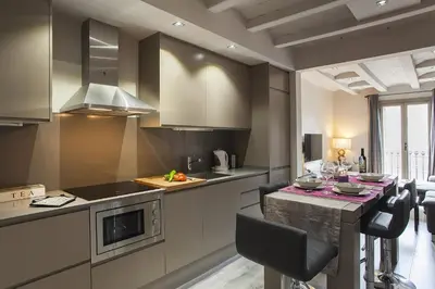 a kitchen with a table and a counter top at Elegant Eixample Apartment nicely decorated in Barcelona