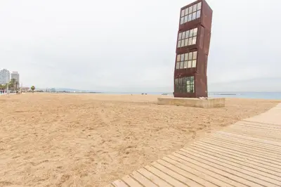 a building on a sandy beach with the ocean at Old City Beach House in Barcelona