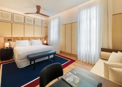 a hotel room with a bed and a couch at H10 Madison 4* Sup in Barcelona