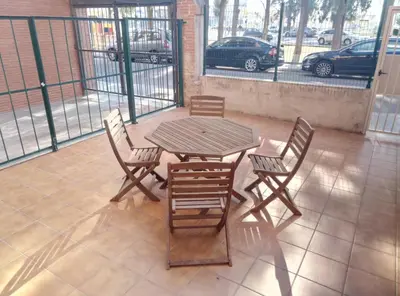 a wooden table and chairs on a patio at Casa Carmen Barcelona in El Prat de Llobregat