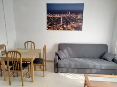 a living room with a couch and a table at Casa Carmen Barcelona in El Prat de Llobregat