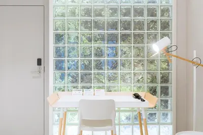 a table with chairs in front of a glass wall at Hotel Rec Barcelona - Adults Only in Barcelona