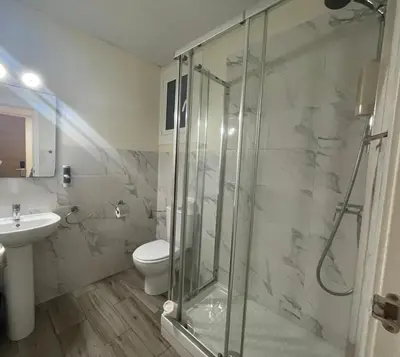 a bathroom with a shower and a toilet and a sink at Hostal Balmes Centro in Barcelona