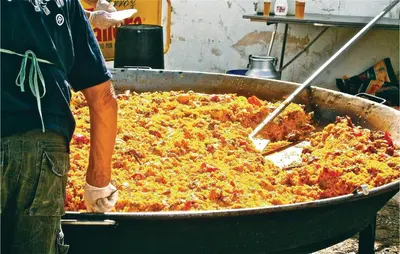 a person is preparing a large dish of food at Nice Home In St Cebrià De Vallalta in Sant Cebrià de Vallalta