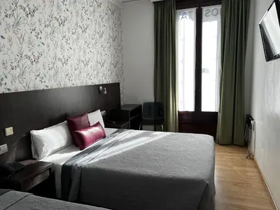 a hotel room with a bed and a window at Ciudad Condal Hostal - Paseo de Gracia in Barcelona